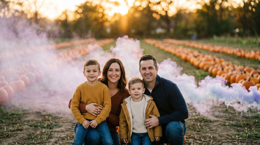 a family of four at a working pumpkin patch during golden hour with colored smoke - Shutter Bombs