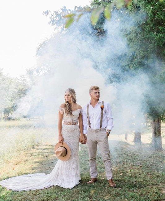 White smoke drifting across a rustic outdoor field with trees — the kind of private-property setting where smoke grenade use is generally unrestricted