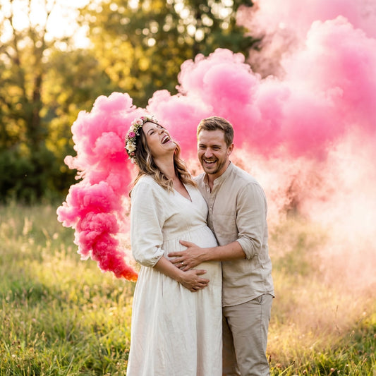 Pink gender reveal smoke filling a sunny grassy field