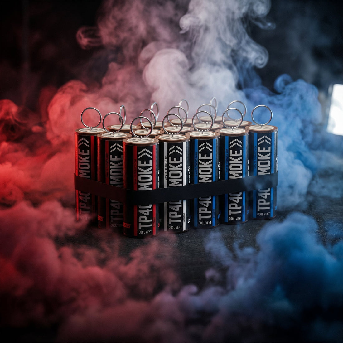 Red and blue smoke canisters on a studio tabletop with dense colored smoke
