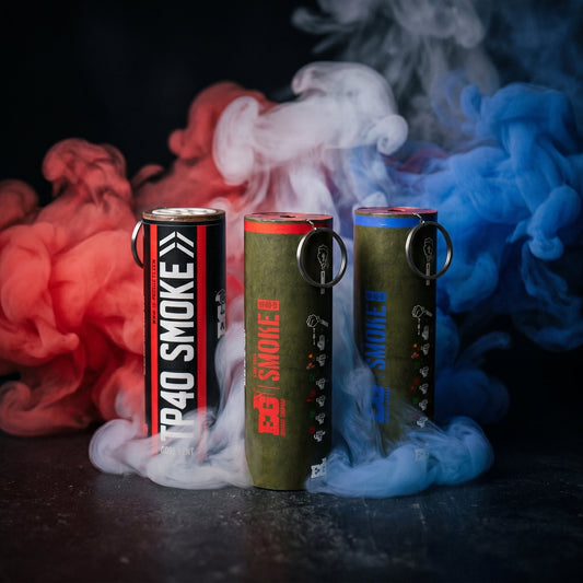 Colored smoke from a smoke grenade drifting through a dark studio setup